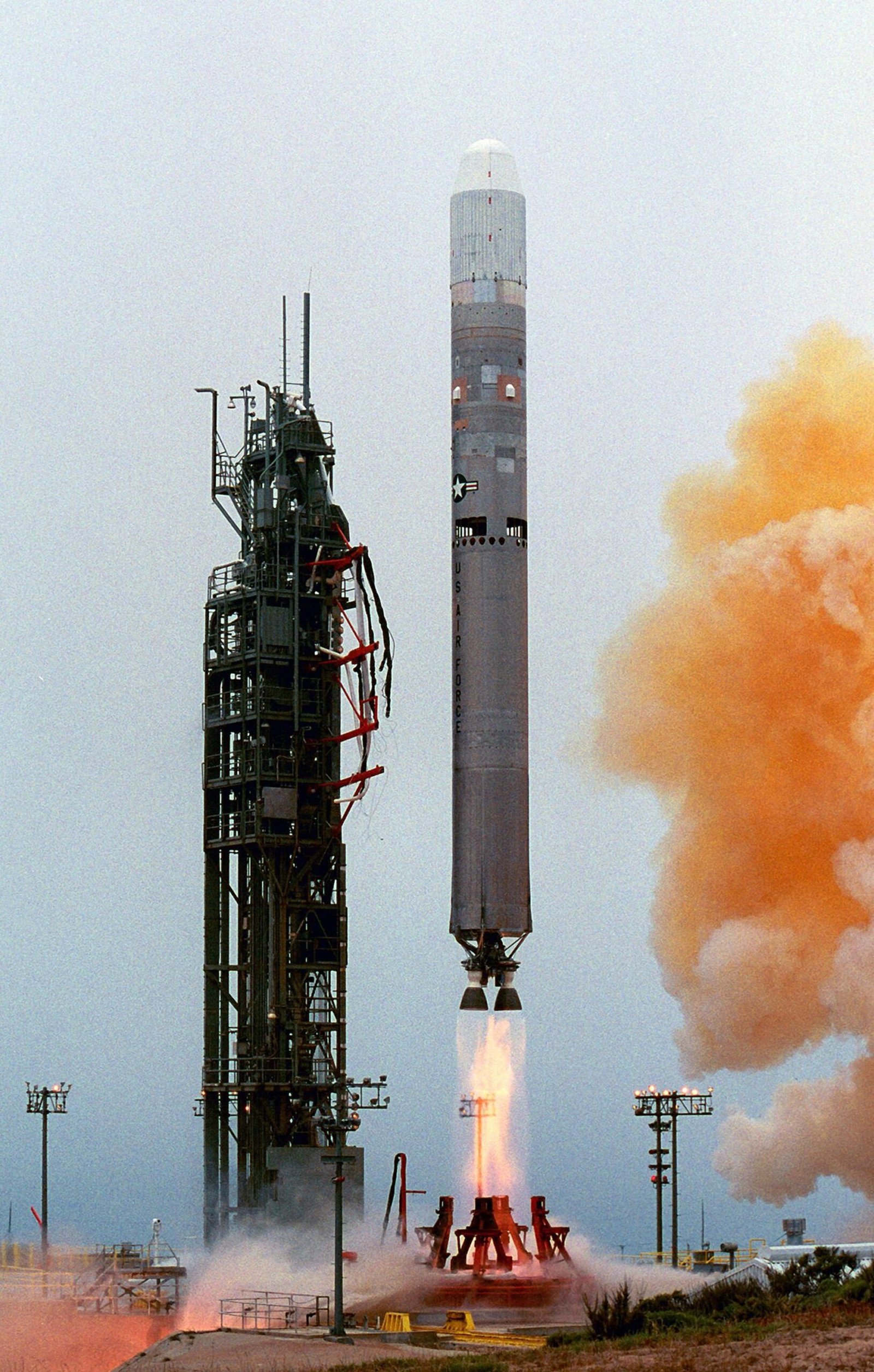 Foguete Titan II deixa a plataforma com chamas e fumaça, em imagem de lançamento.